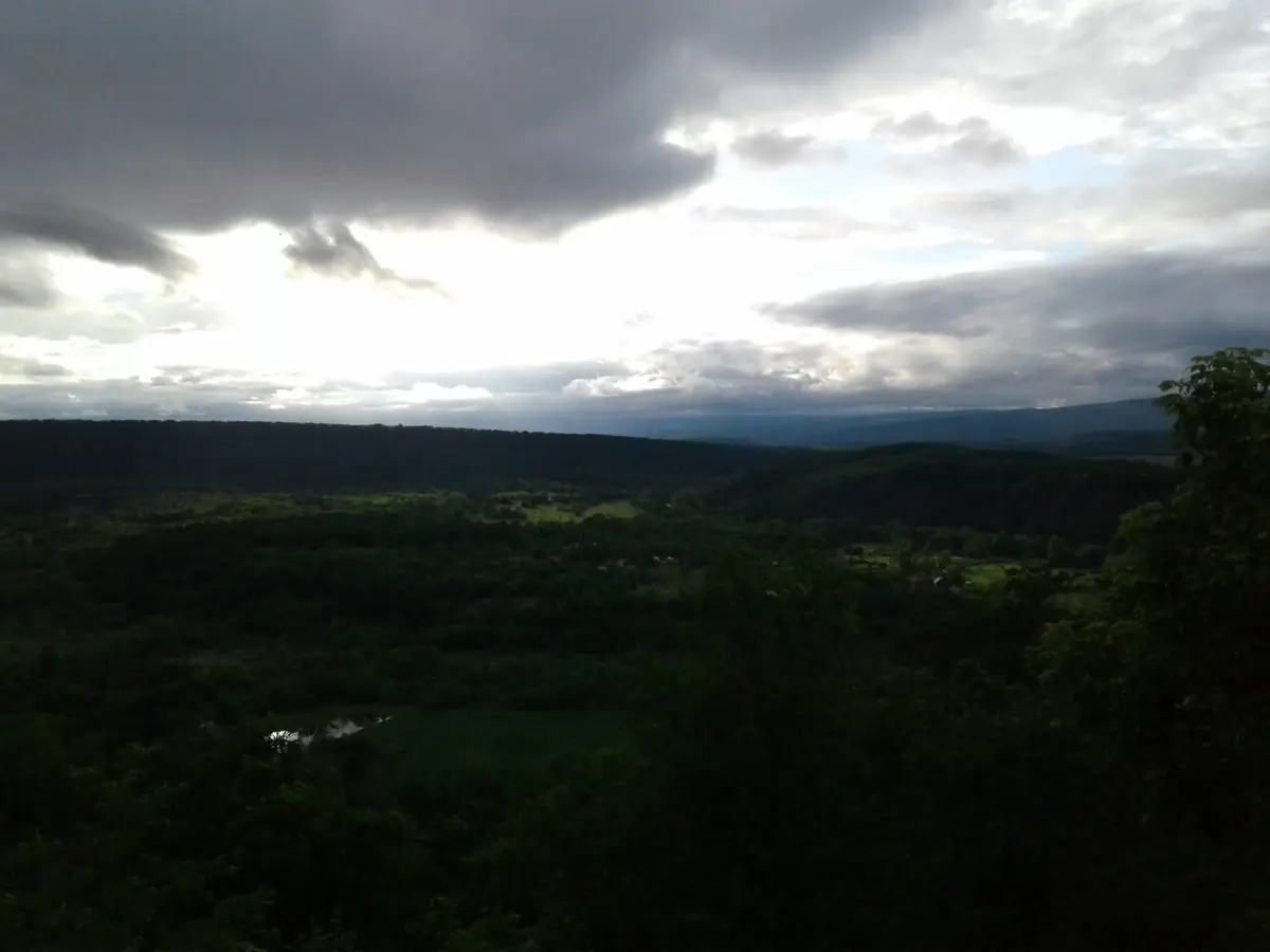 Storm clouds and light over the wooded valley