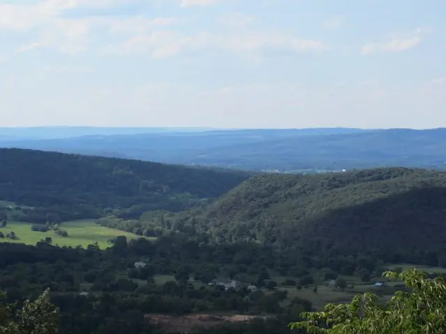 Green valley farmland and distant blue ridges
