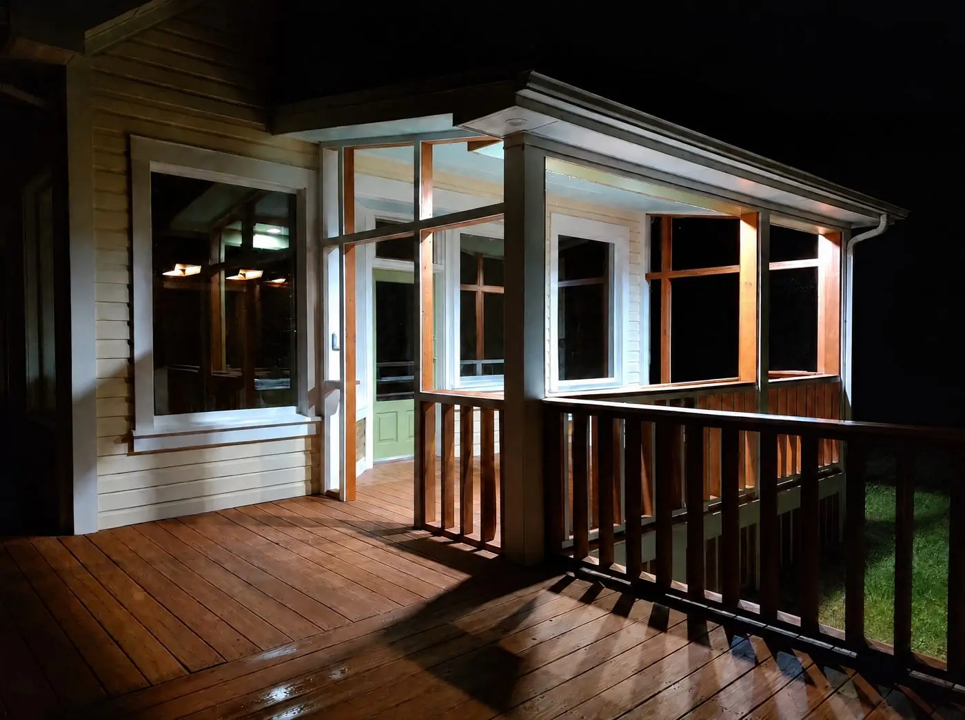 The deck and screened porch lit at night