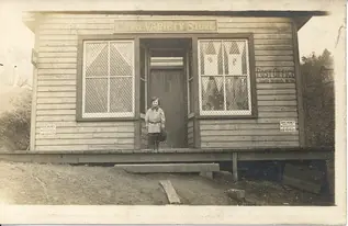 A child on the store steps, circa 1910
