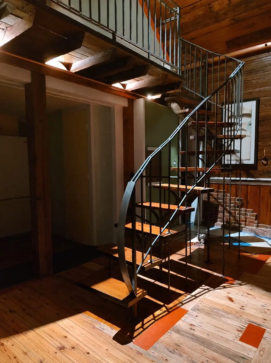 The curving steel and wood loft stair beneath the loft