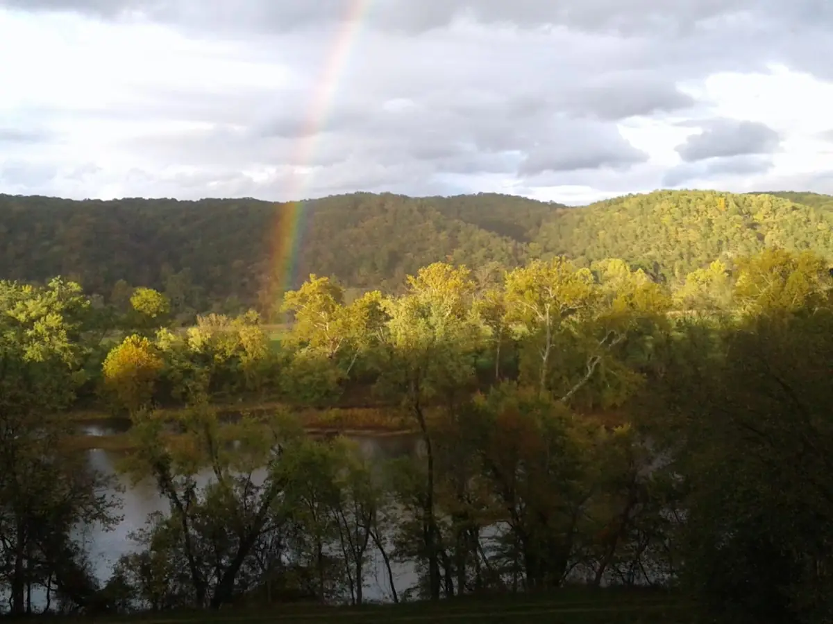 A rainbow over the wooded mountain and the Potomac River