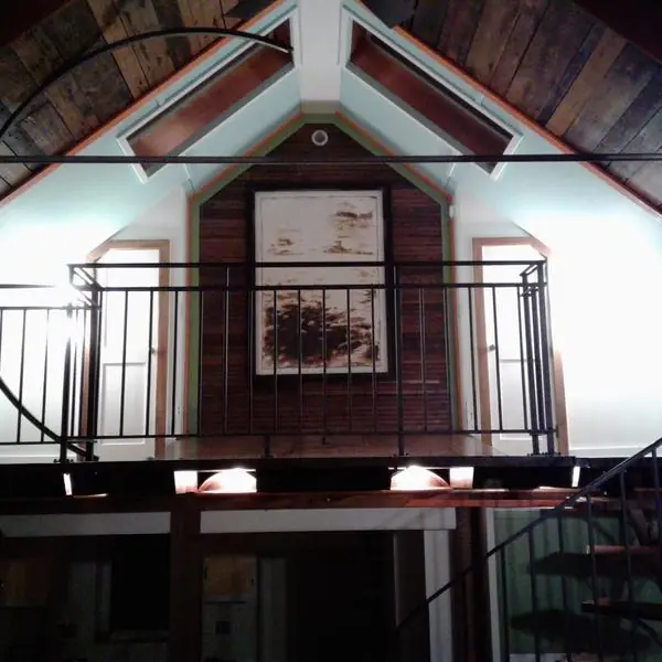Interior, The loft at night, lit from below, with the large framed painting and the curved steel arc, photo 14 of 32