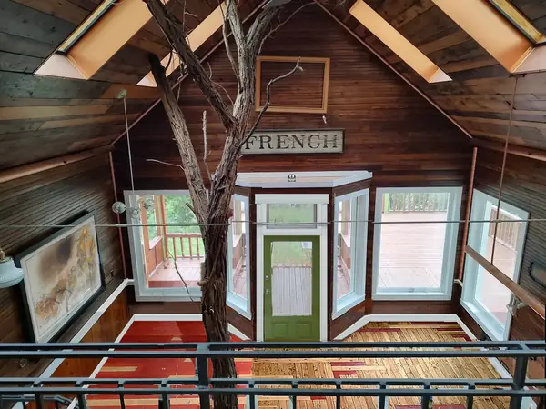Interior, the great room seen from the loft, with the tree, the FRENCH sign and the green door, photo 6 of 32