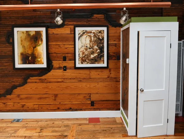 Interior, two Firepaintings on the charred pine wall under the copper beam, beside the white closet and door, photo 22 of 32