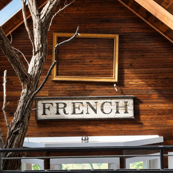 Interior, The antique FRENCH station sign above the empty gold frame, with the tree in front, photo 12 of 32