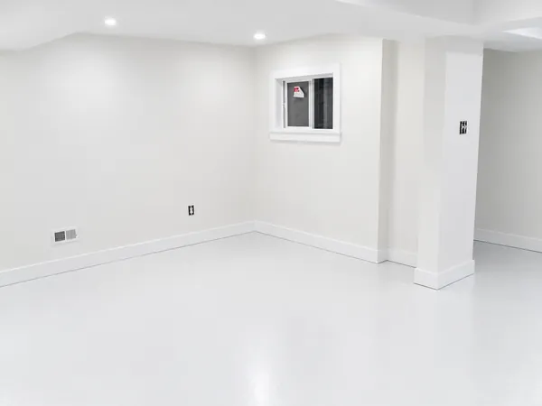 Interior, The freshly finished basement room with a small window and a white floor, photo 26 of 32