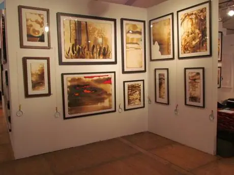 The corner of the booth, with framed Firepaintings hung on two walls